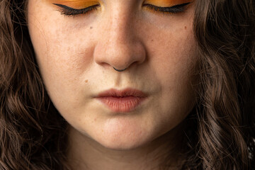 Close up of young woman puckering her lips.