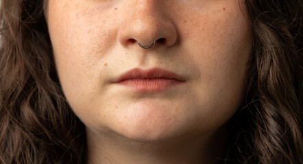 Close up of beautiful young woman with septum nose piercing - obrazy, fototapety, plakaty