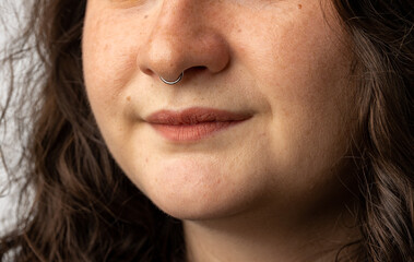 Close up of beautiful young woman with septum nose piercing - obrazy, fototapety, plakaty