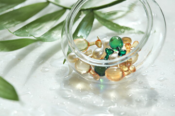 Various serum capsules for healthy skin routine. Anti-wrinkle rejuvenation skin treatment. Beauty product presentation. Off white stone marble background.