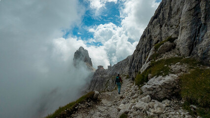 woman hiking and climbing the via ferrata 
