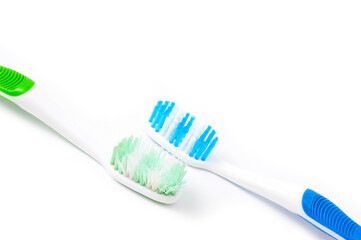 Used and new toothbrushes shot side by side for comparison.