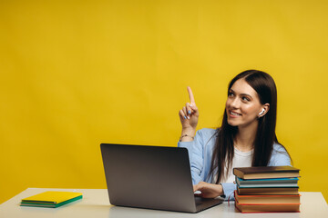 Portrait of attractive smiling smart girl programmer working remotely finance statistics data analysis isolated bright bright shine bright yellow color background. Place for text