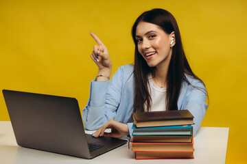 Portrait of attractive smiling smart girl programmer working remotely finance statistics data analysis isolated bright bright shine bright yellow color background. Place for text