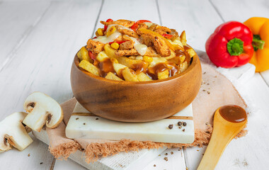 Loaded Poutine Bowl with fries, mushroom, bell peppers and gravy on a white bright background