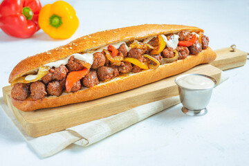 Chorizo Meatball Sandwich with sauce and bell peppers served on a platter with bright white background