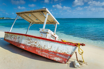 Idyllic beach with rustic wooden fishermen boat in Aruba, Dutch Antilles