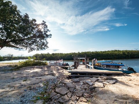 Golden hour at the Jetty in Merang, Terengganu, Malaysia with boats docked on the shore