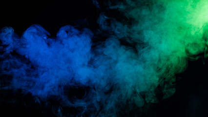 Green-blue smoke in neon light on black background.