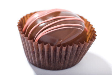 A single piece of chocolate candy on a white background.