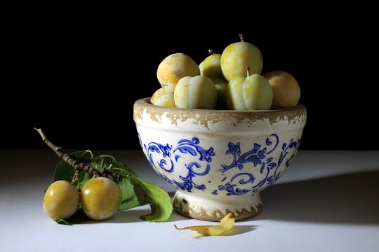 Fresh Ripe Yellow Plums On Black Background