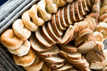 Top view of variety of bread slices and bagels on fourchette table