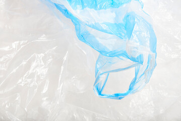 Obraz premium Plastic single use bags. Blue and white wrinkled background. Concepts: sustainability, recycling, pollution.