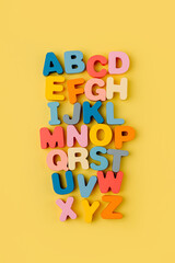 Colorful letters of the alphabet on yellow background. Primary school or preschool, kindergarten....