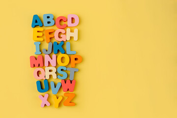 Colorful letters of the alphabet on yellow background. Primary school or preschool, kindergarten....