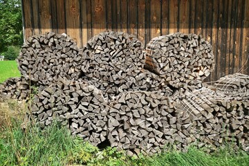 A large amount of firewood under a blue sky