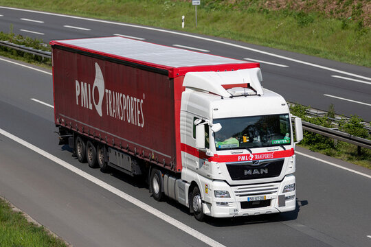 WIEHL, GERMANY - MAY 3, 2022: PML Transportes MAN TGX truck with curtainside trailer on motorway