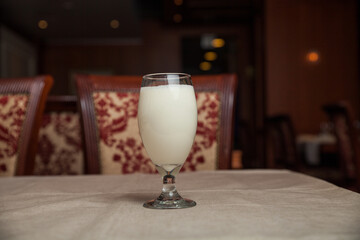 Sweet lassi served in a glass isolated on table top view of indian healthy drink