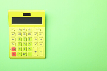 Calculator on green background, top view with space for text. Tax accounting concept