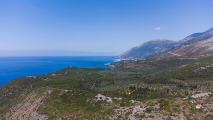 Typical Albanian landscape on the Adriatic shore with mountains. Sunny morning in Albania, Europe. Traveling concept background.