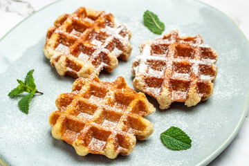 belgian waffles with icing sugar and Whipped Cream. Culinary, cooking, bakery concept. Food recipe background. Close up