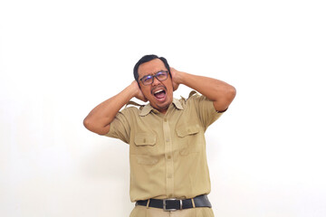Naklejka premium Stressed Indonesian government employees standing while covering his ears. Isolated on white