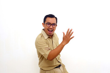 Enthusiastic Indonesian government employees standing while dancing and looking at the camera