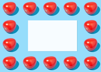 Fototapeta na wymiar Summer mockup - a sheet of paper on a blue background with red ripe tomatoes