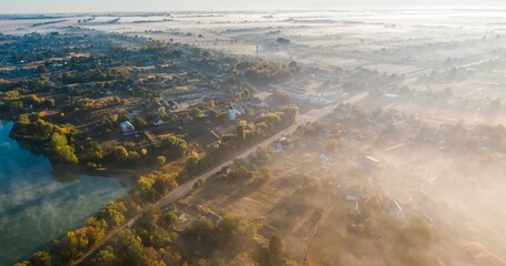 Summer, morning fog, dawn, morning fog over the village, drone view, aerial photography