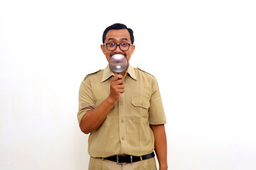 Funny Indonesian government employees standing while holding a magnifying glass. Isolated on white