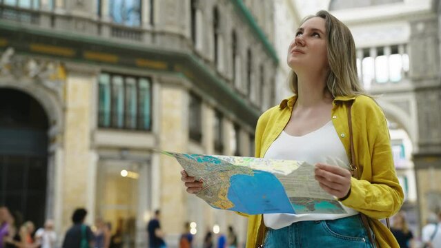 Woman tourist with map stands in the Galleria Umberto in Naples.