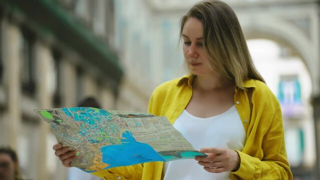 Woman tourist with map stands in the Galleria Umberto in Naples.