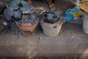 Charcoal stove with traditional waffle making process by the road side