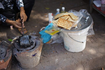Making waffle using traditional method charcoal stove