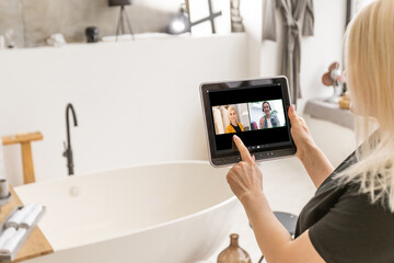 woman with tablet pc during an online consultation in her living room.