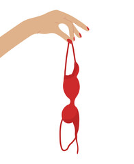 Hand holding red bra in consept of breast awareness. Brassiere hanging isolated.
