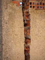 vertical Brick Wall With Crack. Engineering concept and disaster