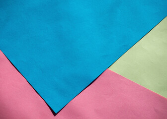 Abstract geometric background with pink, blue and yellow paper