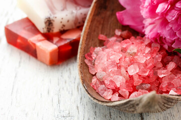 Red sea salt and bars of natural handmade soap on wooden table