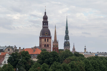 Obraz premium View of Old Riga with 3 church towers. Dome Church, Anglican Church and St. Peter's Church can be seen