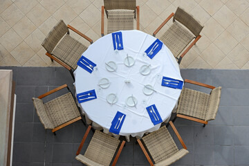 High angle view of setting table and armchairs around it.