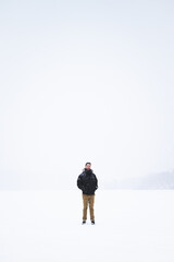 Obraz premium Young man isolated in nature during snowy winter day
