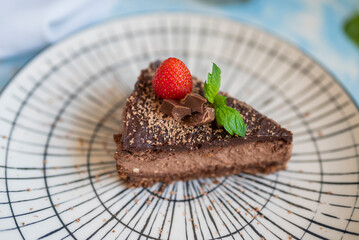 delicious chocolate dessert in a restaurant cheesecake with strawberries and mint leaf