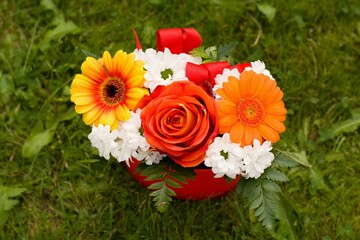 Gift basket with a mixture of flowers in grass