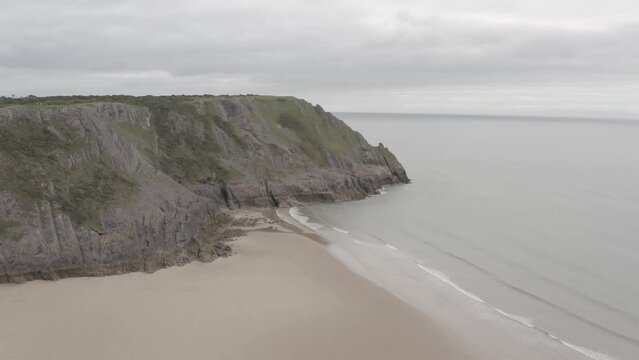 Beautiful drone view of a cliff being wahsed by the waves of the ocean