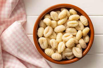 Uncooked potato gnocchi in bowl. Tasty italian food.