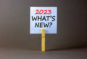2023 what is new symbol. White paper with words 2023 what is new, clip on wooden clothespin....