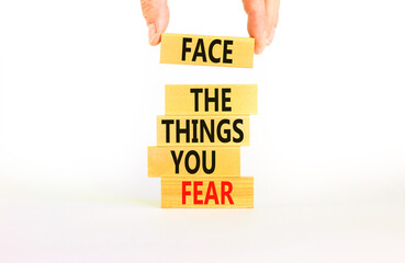 Face the things you fear symbol. Concept words Face the things you fear on wooden blocks on a beautiful white background. Businessman hand. Business and face the things you fear concept. Copy space.