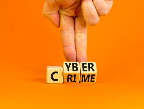 Cyber crime symbol. Concept words Cyber crime on wooden cubes. Businessman hand. Beautiful orange table orange background. Business and cyber crime concept. Copy space.