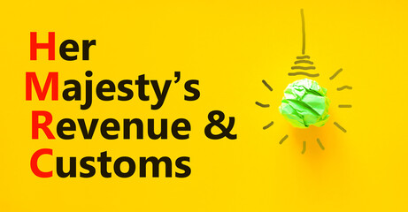 HMRC her majestys revenue and customs symbol. Concept words HMRC her majestys revenue and customs on beautiful yellow background. Business HMRC revenue and customs concept. Copy space.
